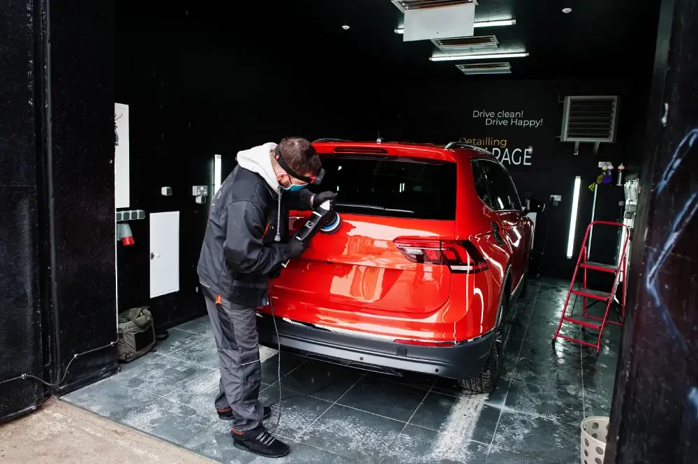 Professional automotive paint correction and buffing on a red SUV by Katazoom.